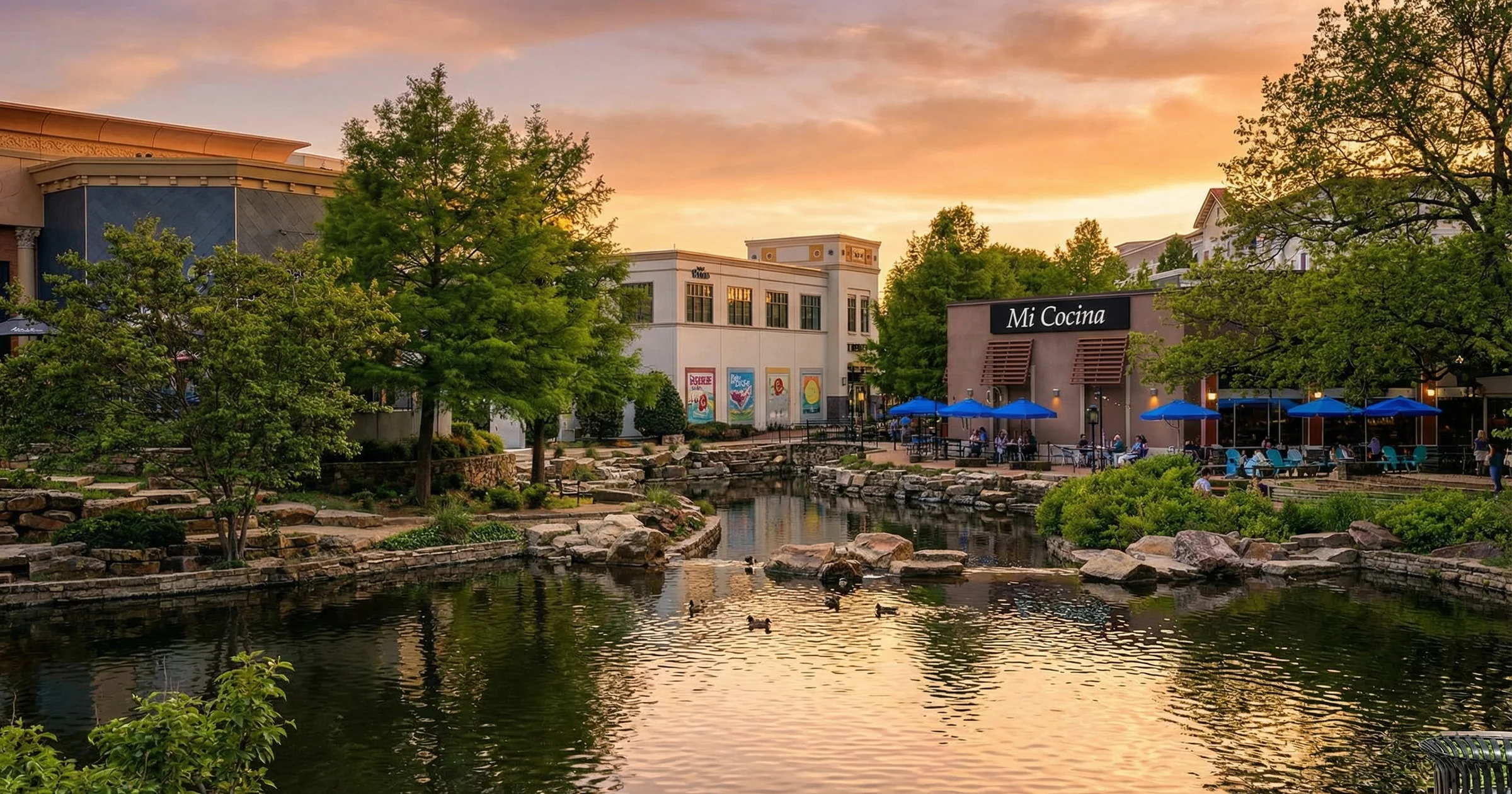 Watters Creek in Allen, Texas at sunset, a pond reflecting shops, trees and a glowing orange sky