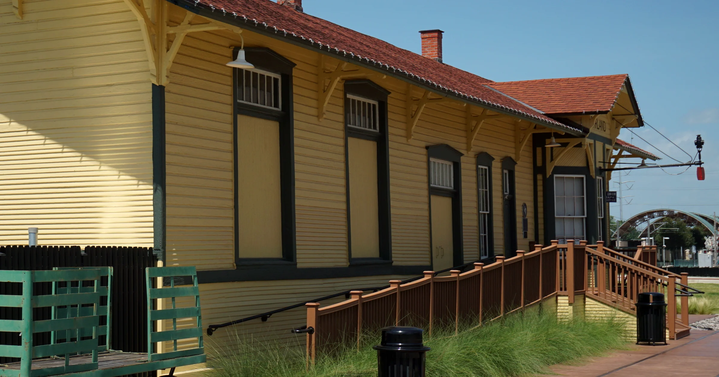 Side of the restored yellow Santa Fe depot, home of the Garland Landmark Museum, in downtown Garland, Texas
