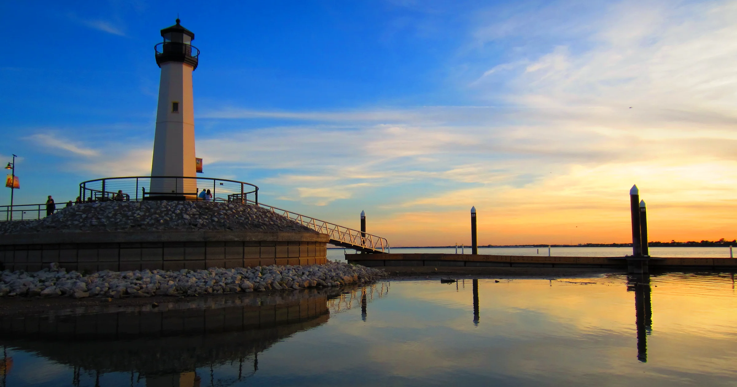 Rockwall Harbor lighthouse on Lake Ray Hubbard at sunset in Rockwall, Texas, reflected in still water